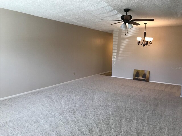 2450 Canadian Way Unit 6, Clearwater, FL 33763 - carpeted empty room featuring a ceiling fan, a chandelier, baseboards, and a textured ceiling