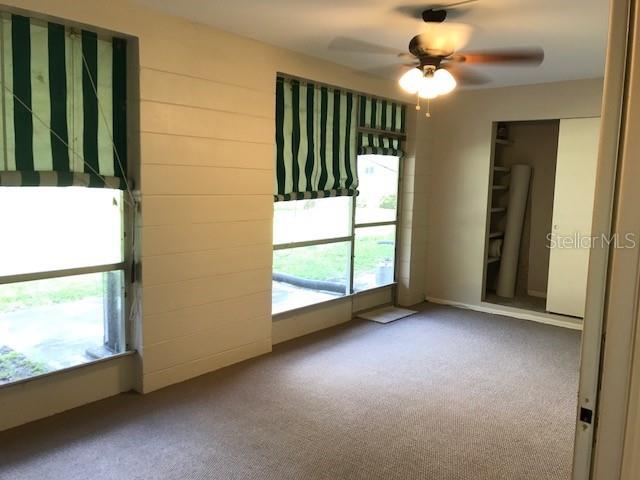 2450 Canadian Way Unit 6, Clearwater, FL 33763 - empty room featuring ceiling fan and carpet flooring