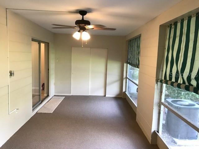 2450 Canadian Way Unit 6, Clearwater, FL 33763 - spare room featuring dark carpet and a ceiling fan