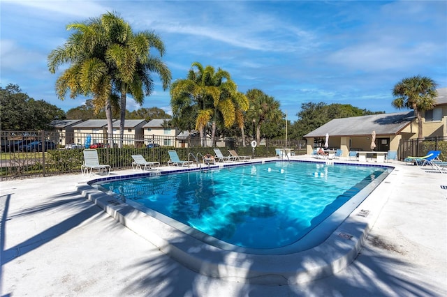 pool featuring fence and a patio area