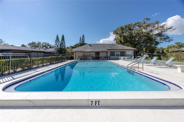community pool featuring fence and a patio area