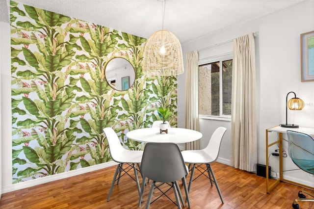 dining room featuring baseboards and wood finished floors