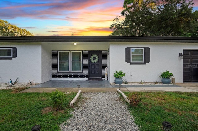 ranch-style house featuring stucco siding