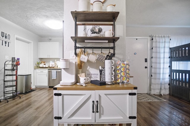 bar featuring stainless steel dishwasher, a textured ceiling, and wood finished floors