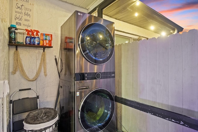 laundry area with laundry area and stacked washer / drying machine