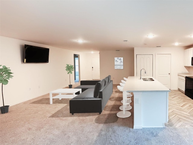 living area with recessed lighting, baseboards, visible vents, and light colored carpet