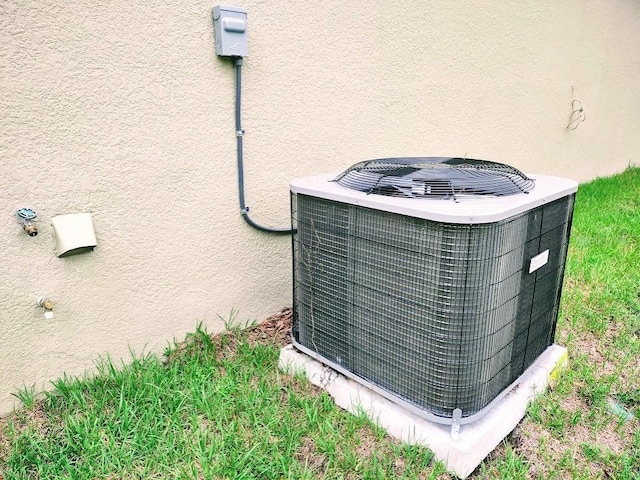 details with central air condition unit and stucco siding