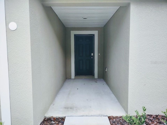 doorway to property with stucco siding