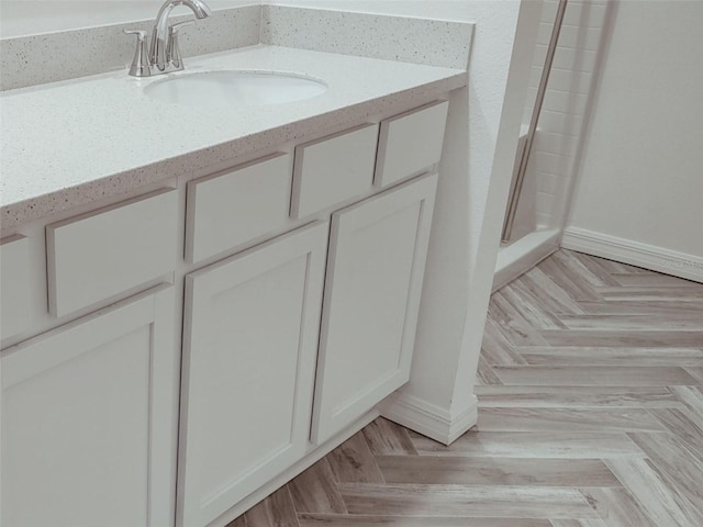 interior details with baseboards and vanity
