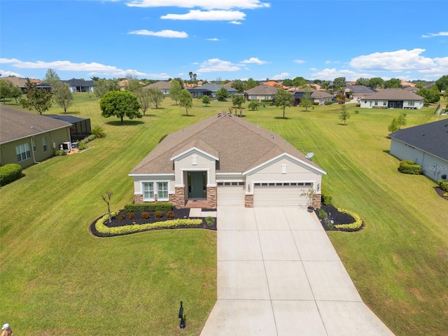 ranch-style home with a front lawn, stone siding, an attached garage, driveway, and a residential view
