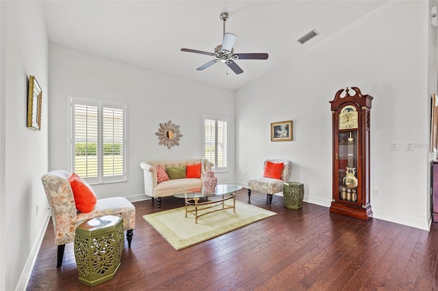 living room with a ceiling fan, visible vents, a healthy amount of sunlight, and hardwood / wood-style floors
