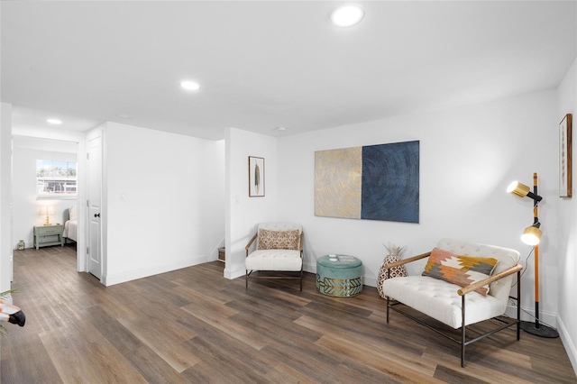 sitting room featuring baseboards, recessed lighting, and wood finished floors