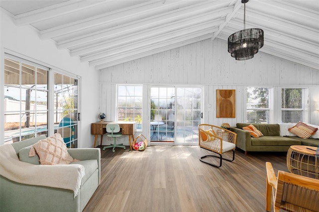 sunroom / solarium featuring outdoor lounge area, wood walls, vaulted ceiling with beams, and wood finished floors