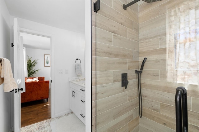 full bathroom featuring vanity and tiled shower