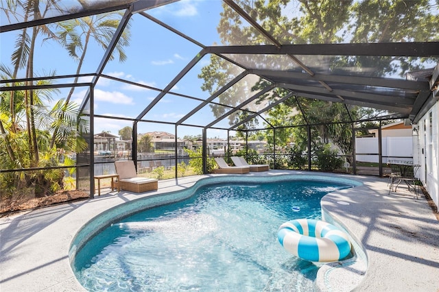 pool featuring a patio and glass enclosure