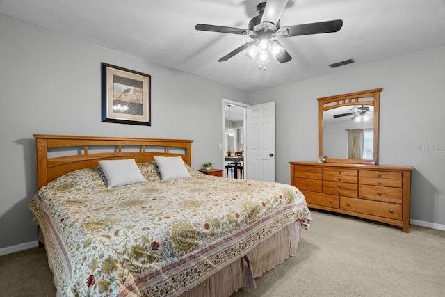 bedroom featuring light colored carpet, a ceiling fan, baseboards, and visible vents