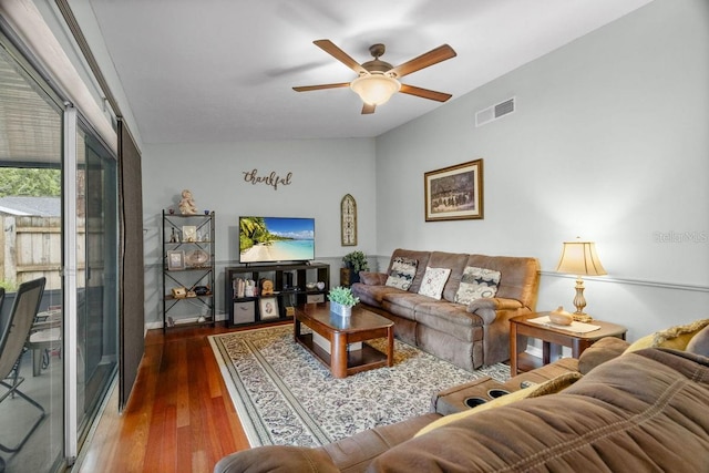 living room with visible vents, ceiling fan, and wood finished floors