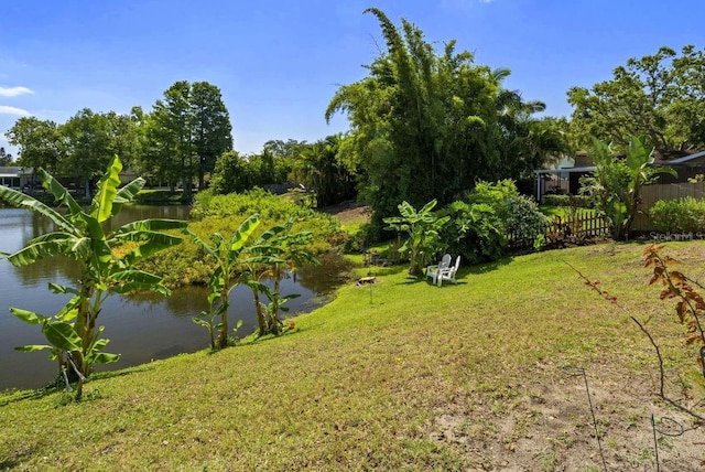 view of yard with a water view and fence