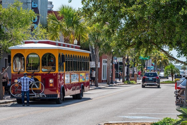 view of street featuring street lights, sidewalks, and curbs