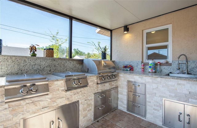 view of patio / terrace featuring a grill, an outdoor kitchen, and a sink