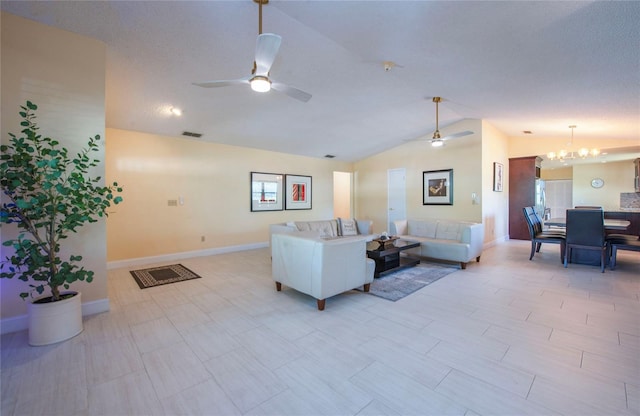 living area with visible vents, baseboards, vaulted ceiling, and ceiling fan with notable chandelier