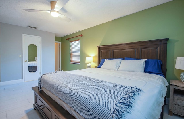 bedroom with a ceiling fan, visible vents, and baseboards