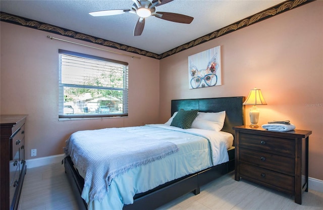 bedroom featuring ceiling fan and baseboards