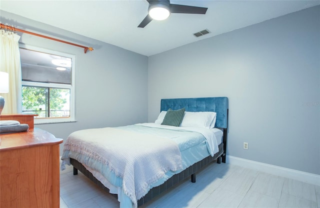 bedroom with baseboards, visible vents, and a ceiling fan