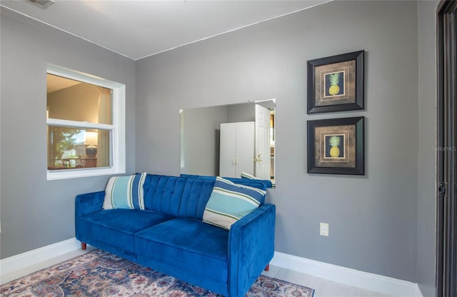 living area featuring baseboards