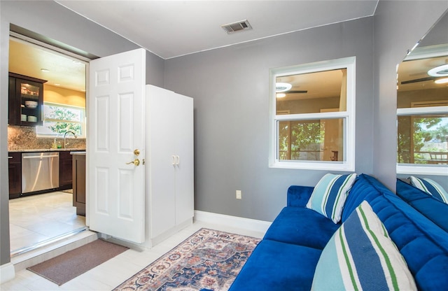 sitting room featuring baseboards, visible vents, and a healthy amount of sunlight