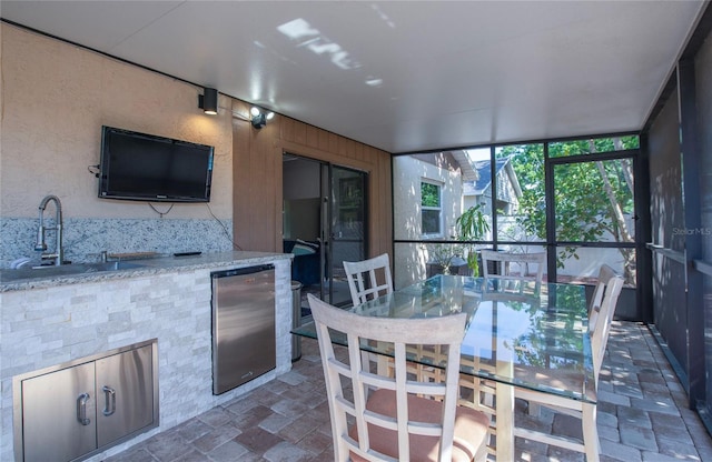 sunroom with a sink