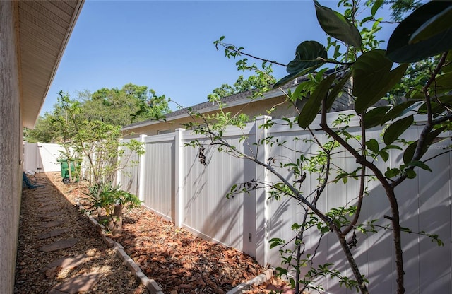 view of side of property featuring fence