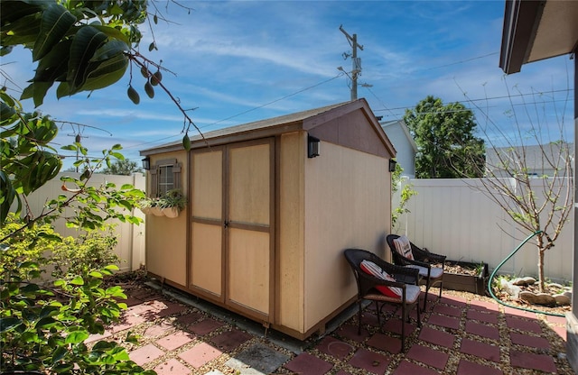 view of shed featuring a fenced backyard
