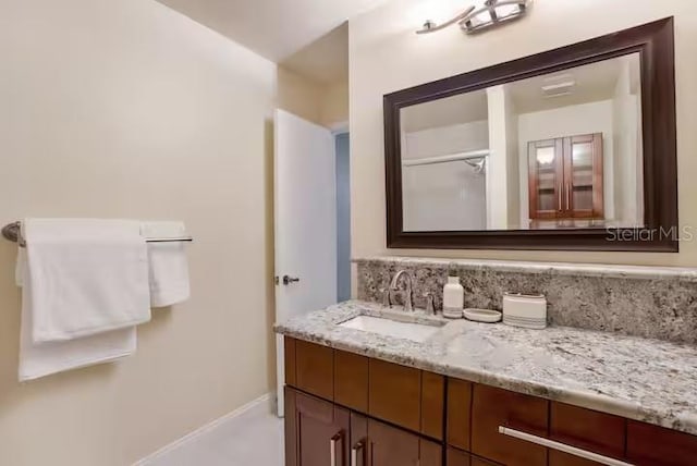 bathroom with vanity and baseboards
