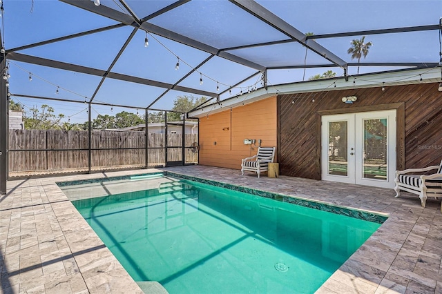 view of pool with fence, a hot tub, a fenced in pool, french doors, and a patio