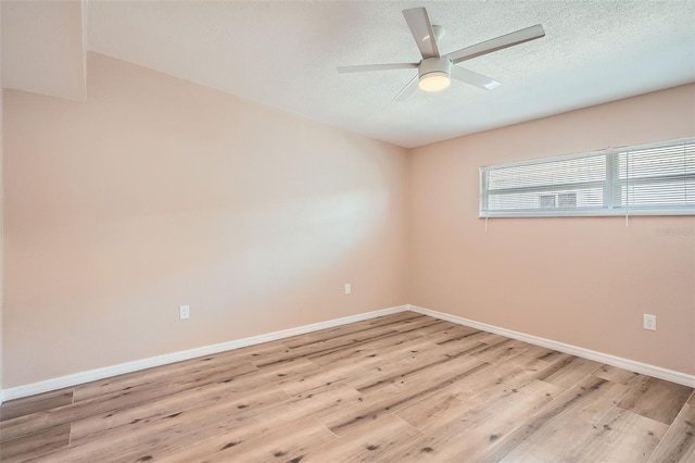 4018 Indianapolis St NE, Saint Petersburg, FL 33703 - unfurnished room featuring light wood-type flooring, a ceiling fan, baseboards, and a textured ceiling