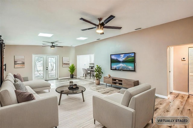 4018 Indianapolis St NE, Saint Petersburg, FL 33703 - living room with ceiling fan, light wood-type flooring, a skylight, and baseboards