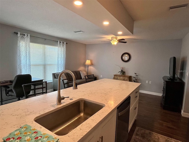 kitchen with a sink, visible vents, recessed lighting, stainless steel dishwasher, and light stone countertops
