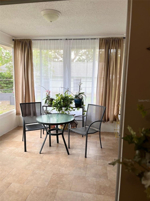 dining space with a textured ceiling