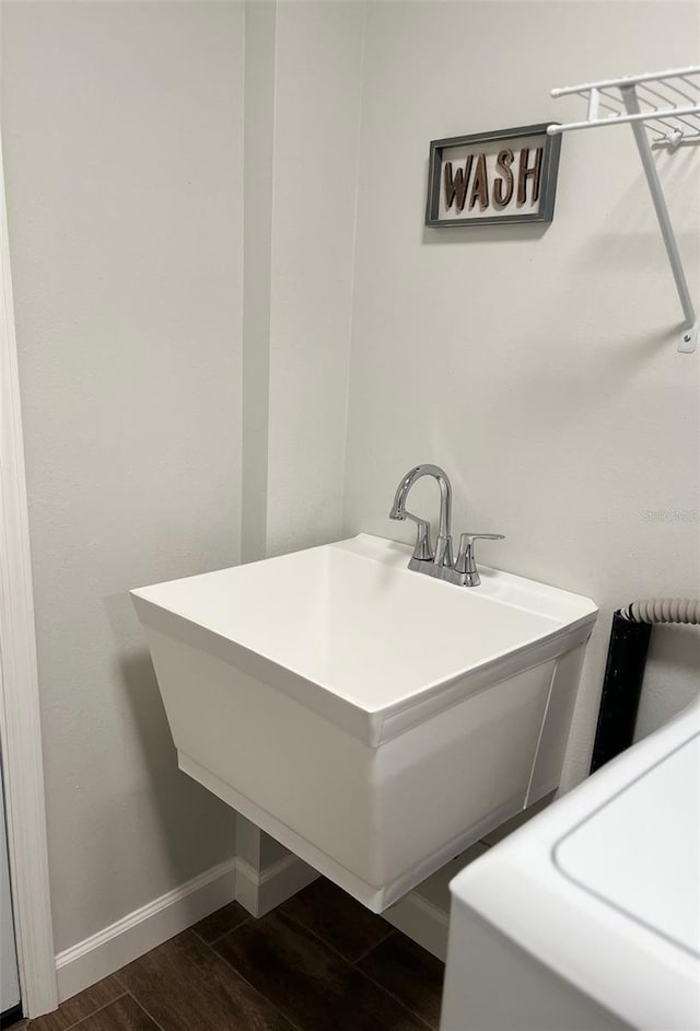bathroom with baseboards and wood finished floors
