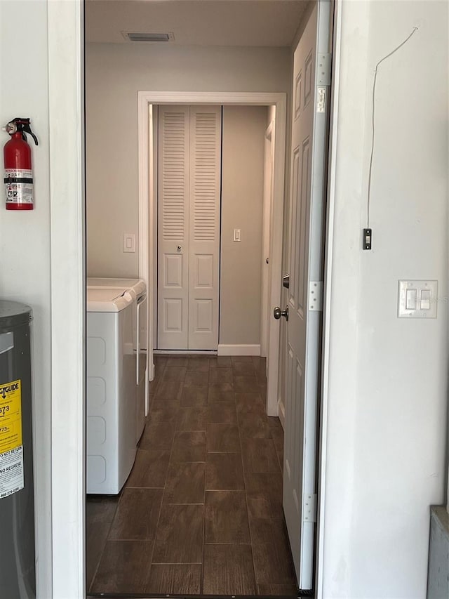 laundry area with washer and dryer, laundry area, visible vents, and electric water heater