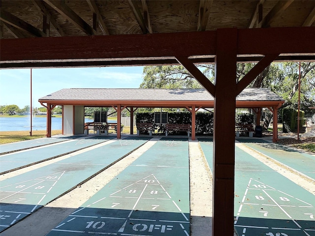 view of community featuring a water view and shuffleboard