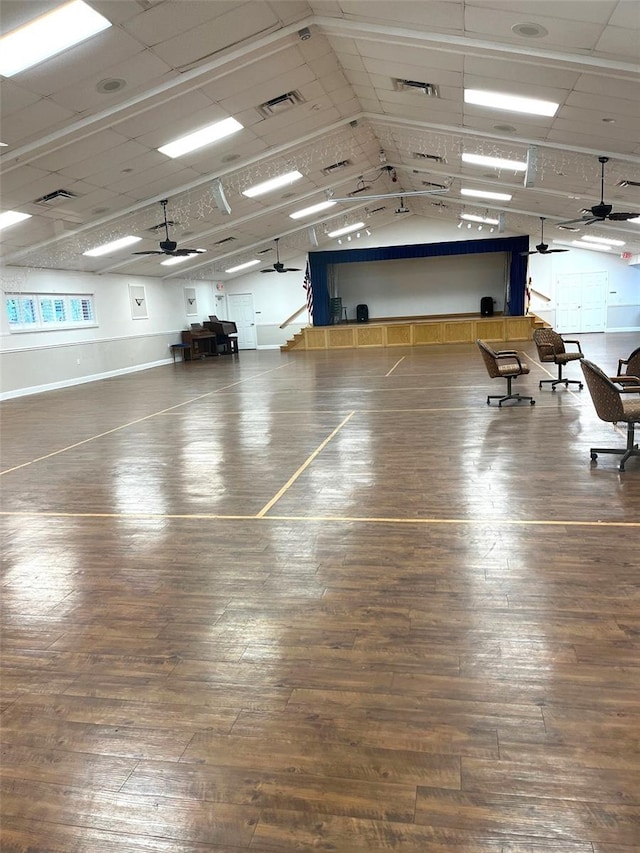 interior space with visible vents, a ceiling fan, and hardwood / wood-style flooring