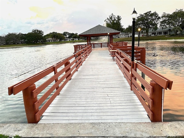 dock area with a gazebo and a water view