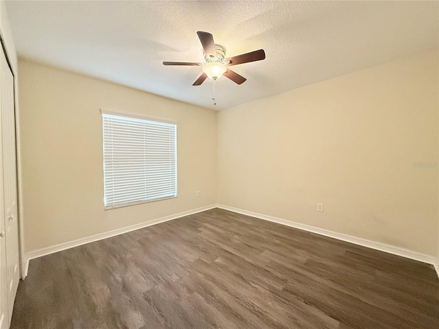 13181 Royal Pines Ave, Riverview, FL 33579 - empty room with dark wood finished floors, ceiling fan, baseboards, and a textured ceiling