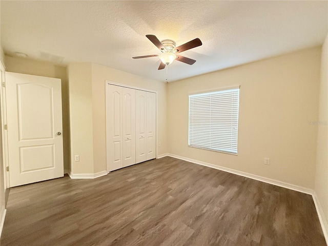 13181 Royal Pines Ave, Riverview, FL 33579 - unfurnished bedroom with dark wood-style floors, baseboards, and a textured ceiling