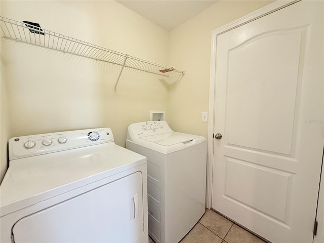13181 Royal Pines Ave, Riverview, FL 33579 - washroom with washing machine and clothes dryer and light tile patterned floors