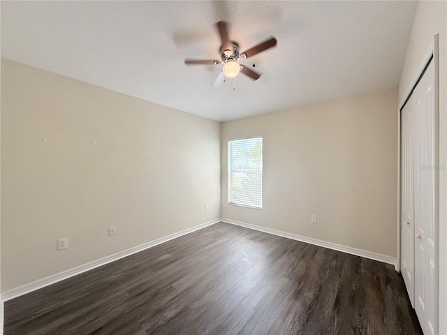 13181 Royal Pines Ave, Riverview, FL 33579 - unfurnished bedroom with dark wood-style floors, a closet, baseboards, ceiling fan, and a textured ceiling