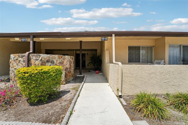 1515 12th Ct SE Unit 55, Largo, FL 33771 - doorway to property with stucco siding