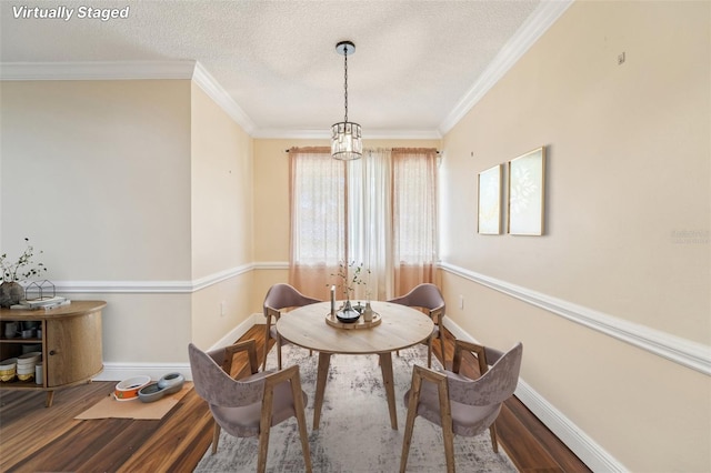 1515 12th Ct SE Unit 55, Largo, FL 33771 - dining room featuring wood finished floors, a textured ceiling, baseboards, and ornamental molding